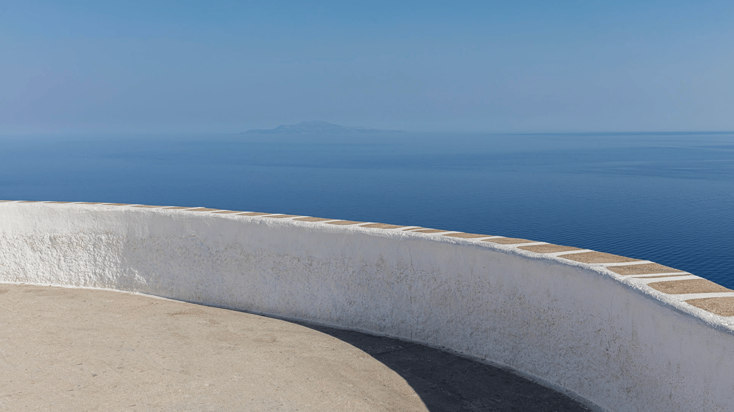Cropped photo of the exterior of the top floor of an old stone building.